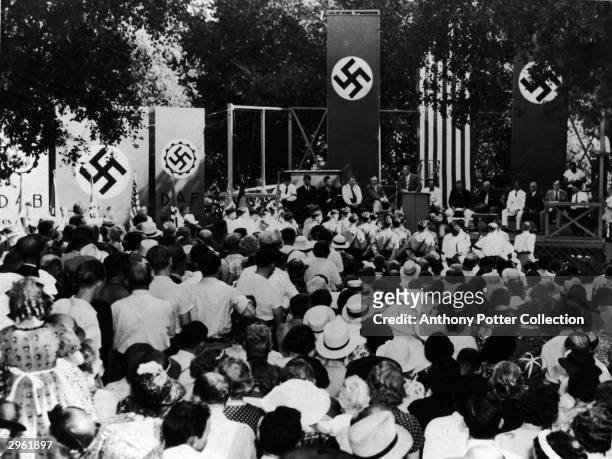 At a pro-Nazi gathering, German-Americans listen to speakers who deny that American Nazi representatives were engaged in subversive activities...
