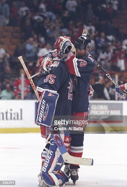 Center Wayne Gretzky of the New York Rangers hugs goaltender Mike Ritcher congratulating him on his shut out during a playoff game against the New...