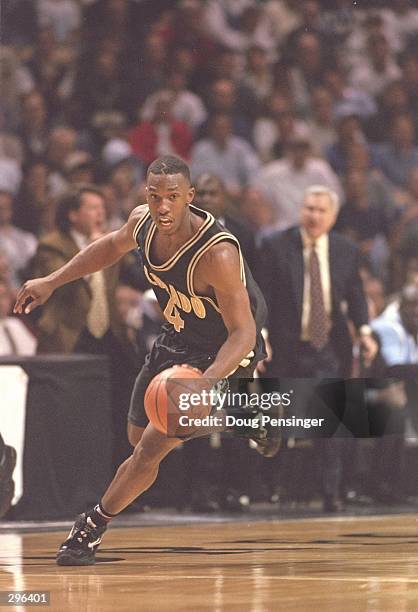 Guard Chauncey Billups of the Colorado Buffaloes dribbles down the court during a playoff game against the North Carolina Tarheels at the Lawrence...