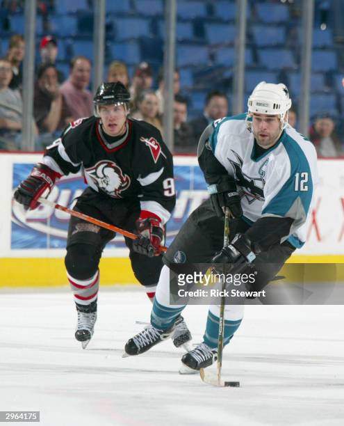 Patrick Marleau of the San Jose Sharks skates up ice ahead of Derek Roy of the Buffalo Sabres on February 10, 2004 at the HSBC Arena in Buffalo, New...