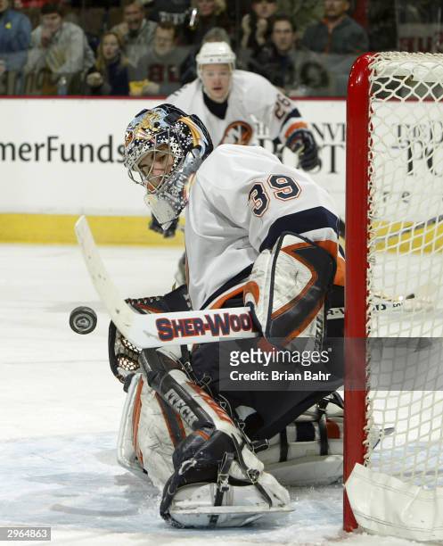 Goalie Rick DiPietro of the New York Islanders stops a shot by the Colorado Avalanche in the first period February 10, 2004 at the Pepsi Center in...