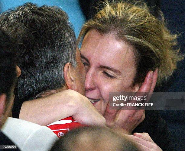 Tunisian national soccer team coach Frenchman Roger Lemerre kisses his wife after Tunisia defeated Nigeria in the semi-final match in the African...