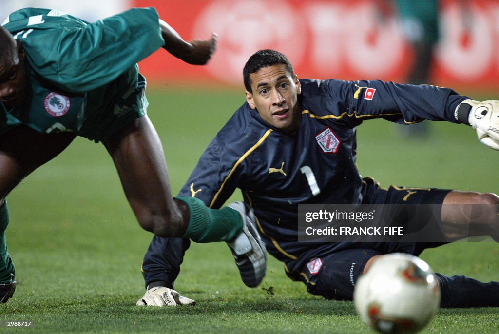 Nigeria's Pius IIkedia (L) challenges Tu