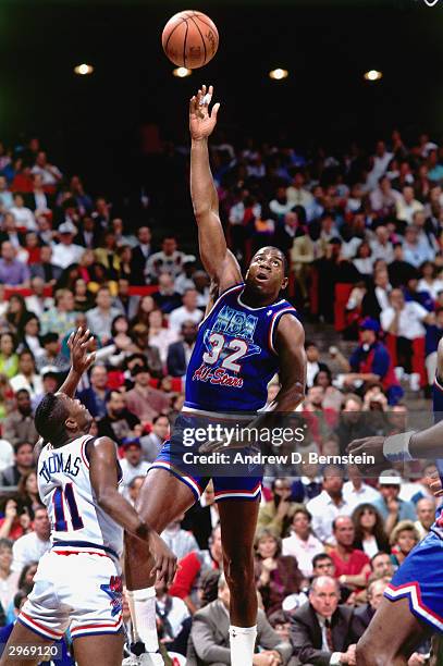 Magic Johnson of the Los Angeles Lakers shoots a hook shot over Isiah Thomas of the Detroit Pistons of the East All-Stars during the 1992 NBA...