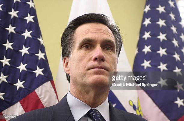 Massachusetts Governor Mitt Romney listens to a reporter's question during a news conference prior to the legislature's Constitutional Convention to...