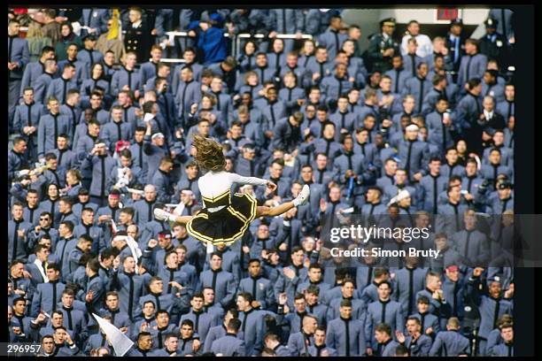 Cheerleaders do a routine during a game between the Army Black Knights and the Navy Midshippmen at Veterans Stadium in Philadelphia, Pennsylvania....