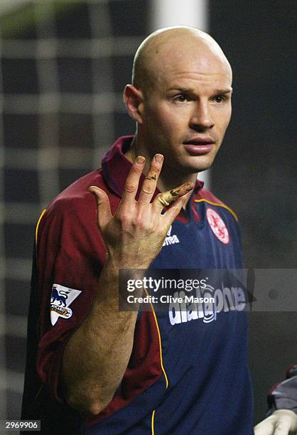 Danny Mills of Middlesbrough shows his damaged finger during the FA Barclaycard Premiership match between Manchester United and Middlesbrough on...