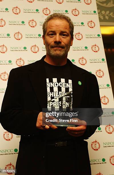 Actor Peter Mullan poses with his award for Best British Screenwriter at the 24th Awards of the London Film Critics' Circle in aid of the NSPCC at...