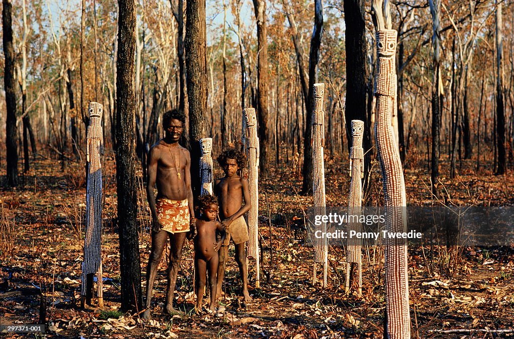 Australia,Arnhem Land,Aboriginal family amongst sculptures in wood