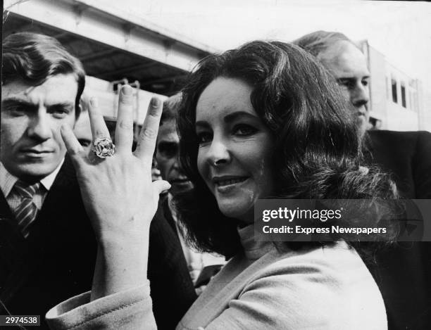 British-born actress Elizabeth Taylor shows off the 33.19 carat diamond ring given to her by husband Richard Burton.