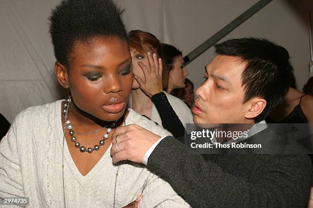 Jeffrey Chow helps a model get ready backstage at the Jeffrey Chow Fall 2004 during Olympus Fashion Week February 12, 2004 in New York City.