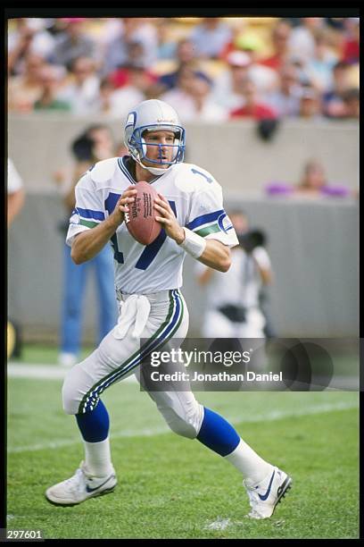 Quarterback Dave Krieg of the Seattle Seahawks looks to pass the ball during a game against the Chicago Bears at Soldier Field in Chicago, Illinois....