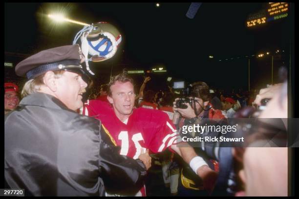 Quarterback Joe Montana of the San Francisco 49ers pushes through the crowd after winning the Super Bowl XXIII game against the Cincinnati Bengals at...