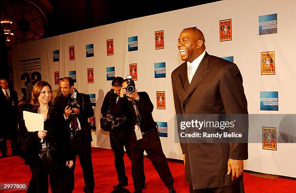 Earvin Magic Johnson acknowledges his fans and the media on the red carpet of the Shrine Auditorium as part of "American Express Celebrates the...