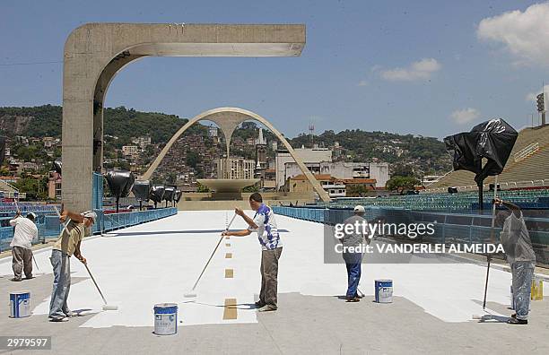 Workers paint the track of the Sambodrome 13 February, 2004 in Rio de Janeiro, Brazil, in preparation for the upcoming carnival parade on 22 and 23...
