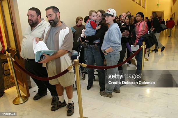 Hundreds of gay couples line up in front of the County Clerk's office at San Francisco City Hall to register for marriage forms on February 13, 2004...