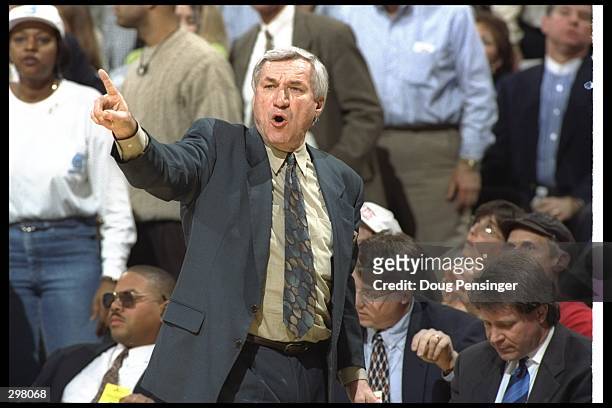 Coach Dean Smith of the North Carolina Tarheels gives instructions to his players during a playoff game against the Wake Forest Demon Deacons at the...