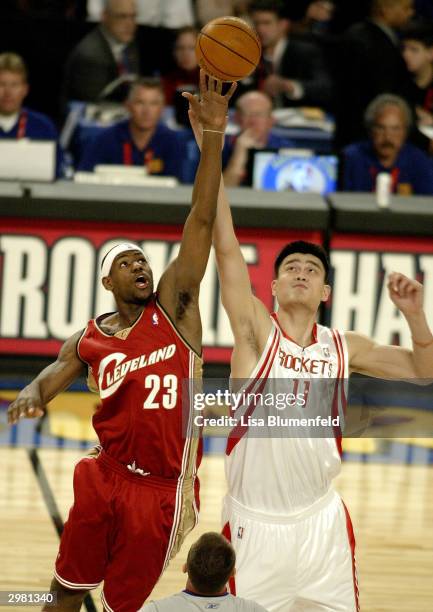 Lebron James from the Cleveland Cavaliers of the Rookie Team tips off against Yao Ming from the Houston Rockets of the Sophomore Team during the Got...