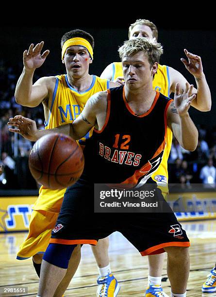 Singer Nick Carter is covered by actors Steve Howey and Michael Rapaport in the NBA All-Star Celebrity Game on February 13, 2004 at the Los Angeles...