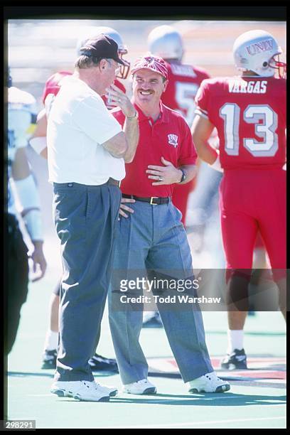 University of Nevada Las Vegas head coach Jeff Horton talks with one of his assistants during game against the University of Wyoming Cowboys at Sam...
