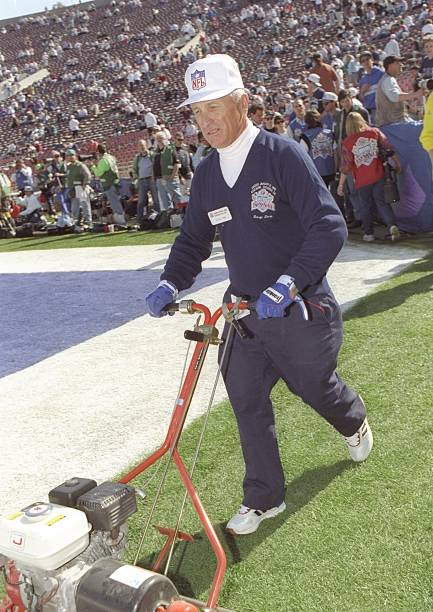 Groundskeeper George Toma touches up the green during the Super Bowl XXVII pre-game between the Dallas Cowboys and the Buffalo Bills at the Rose Bowl...