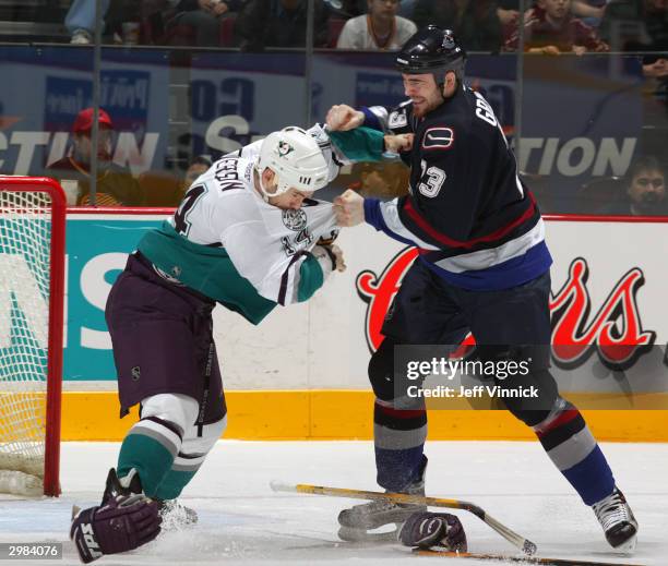 Martin Grenier of the Vancouver Canucks and Cam Severson of the Mighty Ducks of Anaheim exchange punches as they fight during the first period of...