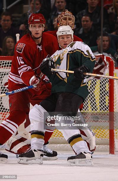 Brad Ference of the Phoenix Coyotes battles for position in front of the net with Brenden Morrow of the Dallas Stars on February 14, 2004 at Glendale...