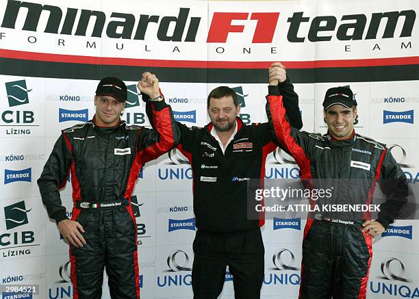 Leader of Minardi Formula One team Paul Stoddart raises hands with teammates, Italian Gianmaria Bruni and Hungarian Zsolt Baumgartner in Budapest, 15...