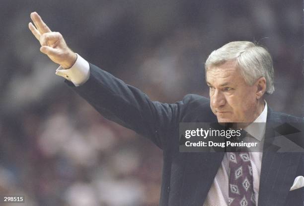 Coach Dean Smith of the North Carolina Tarheels gives instructions to his players during a playoff game against the Colorado Buffaloes at the...