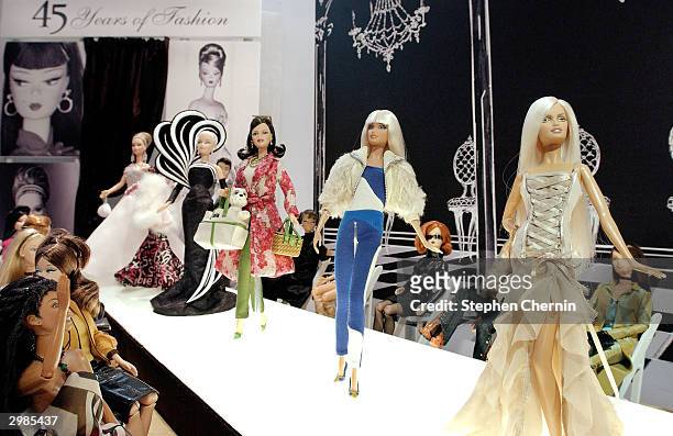 Mattel celebrates 45 years of fashion with a runway display featuring Barbie dolls modelling clothes by famous designers such as Versace, Kate Spade...