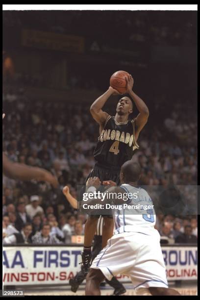 Guard Chauncey Billups of the Colorado Buffaloes shoots the ball as guard Shammond Williams of the North Carolina Tarheels tries to guard him during...