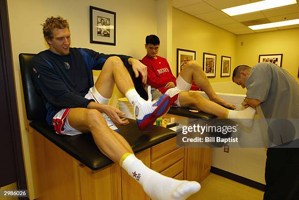 Dirk Nowitzki of the Dallas Mavericks and Yao Ming of the Houston Rockets gets ready in the Western Conference Locker room prior the 2004 NBA...