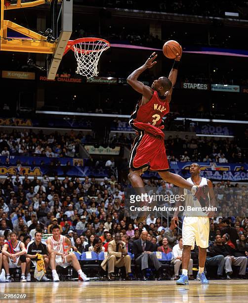 Freshman Dwyane Wade of the Miami Heat goes for a dunk against the Sophomore team during the Got Milk? Rookie Challenge, a part of the 2004 NBA...