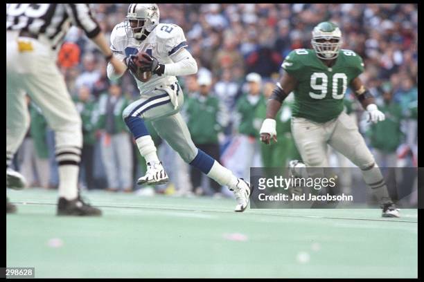 Defensive back Deion Sanders of the Dallas Cowboys moves the ball during a playoff game against the Philadelphia Eagles at Texas Stadium in Irving,...