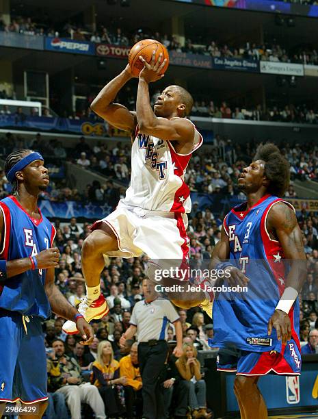 Steve Francis from the Houston Rockets of the Western Conference All-Stars attempts a shot against Jermaine O�Neal from the Indiana Pacers and Ben...