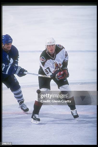 Center Jeremy Roenick of the Phoenix Coyotes chops it out during a game with the Toronto Maple Leafs at the American West Arena in Phoenix, Arizona....