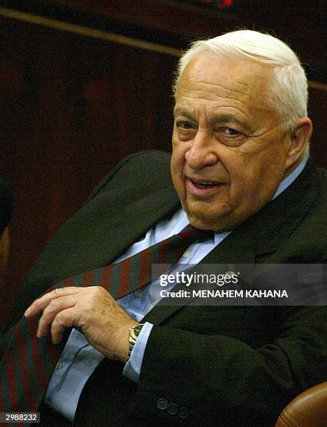 Israeli Prime Minister Ariel Sharon gestures during a session in the Knesset to defend his government's record during its first year in office, as...