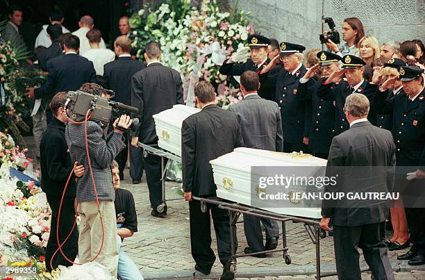 The coffins containing the remains of Melissa Russo and Julie Lejeune are carried into Liege's Saint Martin Basilica during their funerals, 22 August...