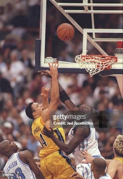 Center Makhtar Ndiaye of the North Carolina Tarheels and forward Tony Gonzalez of the California Bears fight for a rebound during a playoff game at...