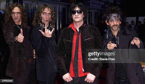 Rock Band The Darkness arrive at the "Brit Awards 2004" at Earls Court 2 on February 17, 2004 in London. Darkness is nominated for best British Group.