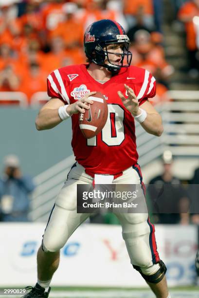 Quarterback Eli Manning of the Mississippi Rebels looks for the open receiver during the SBC Cotton Bowl against the Oklahoma State Cowboys on...