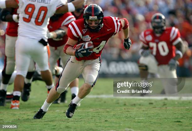 Wide receiver Bill Flowers of the Mississippi Rebels runs the ball after a reception against the Oklahoma State Cowboys during the SBC Cotton Bowl on...