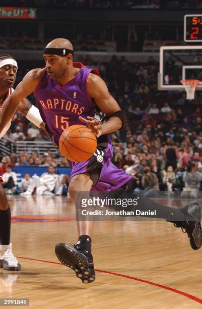 Forward Vince Carter of the Toronto Raptors drives against forward Eddie Robinson of the Chicago Bulls ducks out of the way during a game on February...