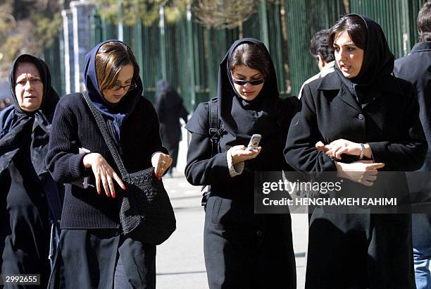 Iranian students walk outside Tehran university 18 February 2004. Iranians are called 20 February 2004 to elect a new parliament, with incumbent...