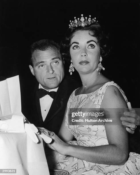 British-born actor Elizabeth Taylor sits with her third husband, American film producer Mike Todd , at a Golden Globe Awards ceremony at the Coconut...