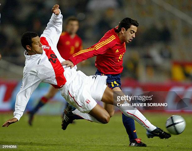 Peru's Carlos Zegarra fights for the ball with Spain's Xavi Hernandez during their friendly match at Olimpic Lluis Companys stadium in Barcelona, 18...
