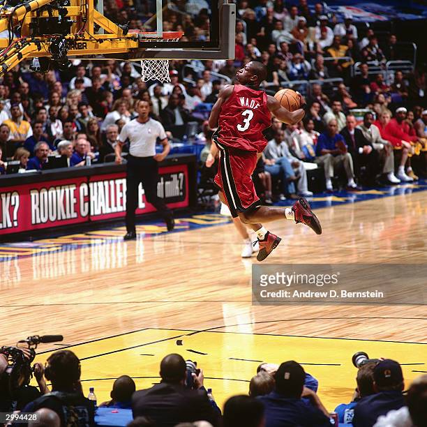 Dwyane Wade of the Rookie Team drives to the basket for a dunk against the Sophomore Team during the Got Milk? Rookie Challenge, a part of the 2004...