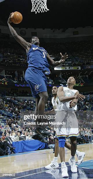 Kwame Brown of the Washington Wizards goes up for a dunk over David West of the New Orleans Hornets in NBA action February 18, 2004 at the New...