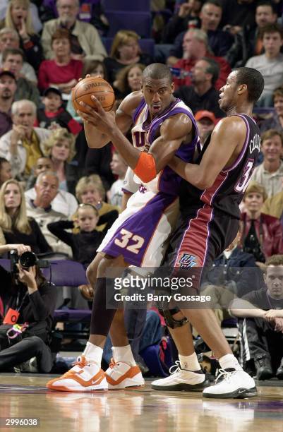Amare Stoudemire of the Phoenix Suns posts up Jarron Collins of the Utah Jazz during the game at America West Arena on February 7, 2004 in Phoenix,...