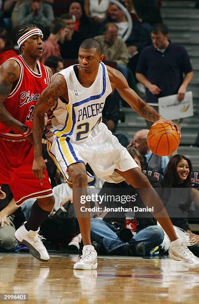 Jonathan Bender of the Indiana Pacers posts up Eddie Robinson of the Chicago Bulls during the game at the United Center on February 10, 2004 in...